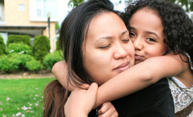 Young girl hugging her mother