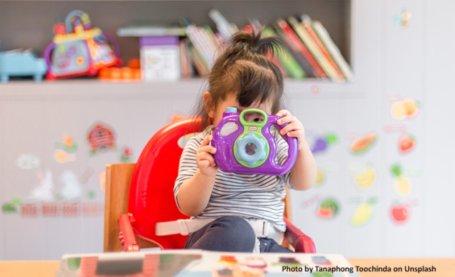 Female toddler playing with toy in daycare