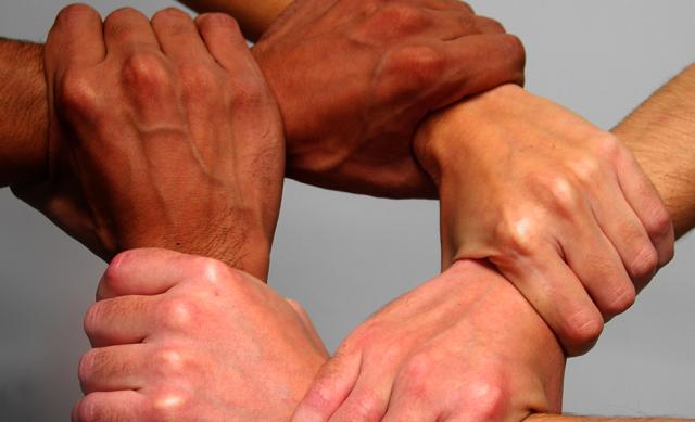 Interlocking hands of diverse people