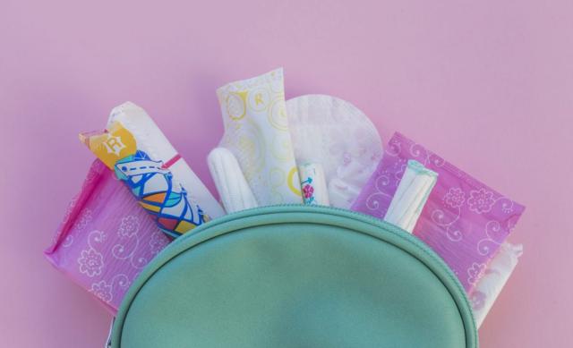 Menstrual products fanned out from inside small wallet