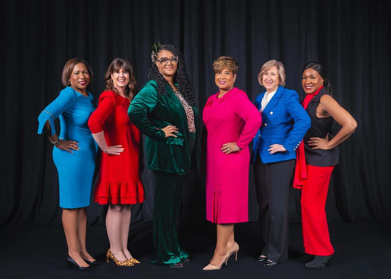 Group photo of the six 2024 YWCA Women of Achievement standing in front of a dark blue curtain background. 