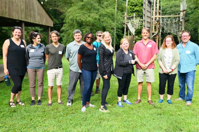 Group of faculty in active wear standing in line facing camera