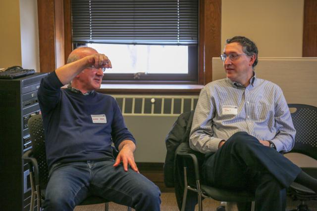 two men have a conversation while seated