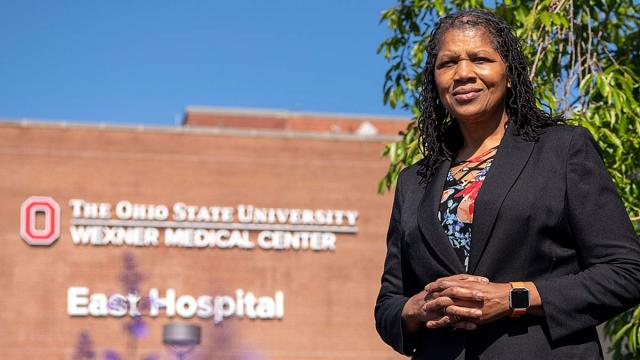 A woman standing in front of the ohio state university wexner medical center