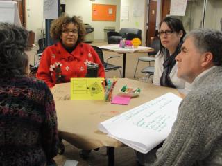 Four people having seated conversation