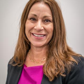 Woman in business professional clothes smiling