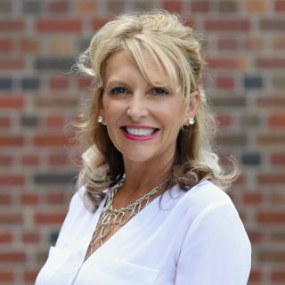 Sherry McNarry, White Top, Blonde Hair, Brick wall