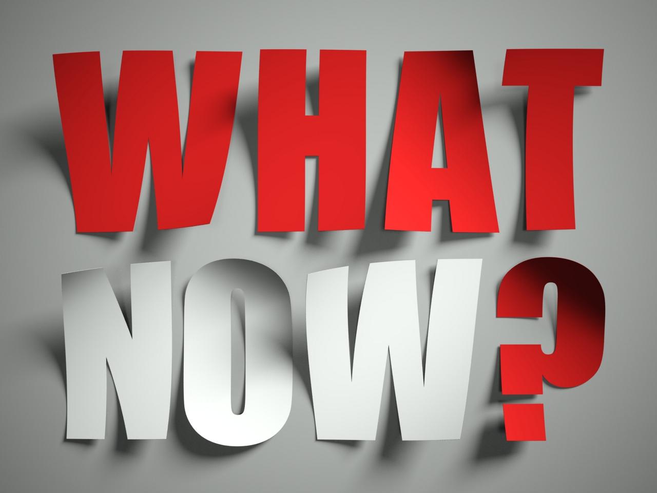 Paper cut-outs of the words "What Now?"