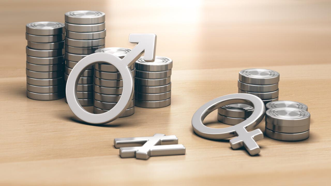 Two stacks of coins, larger stack has male gender symbol on it, small stack has female gender symbol on it